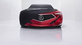 Front of Precision Concept vehicle partially draped with car cover.