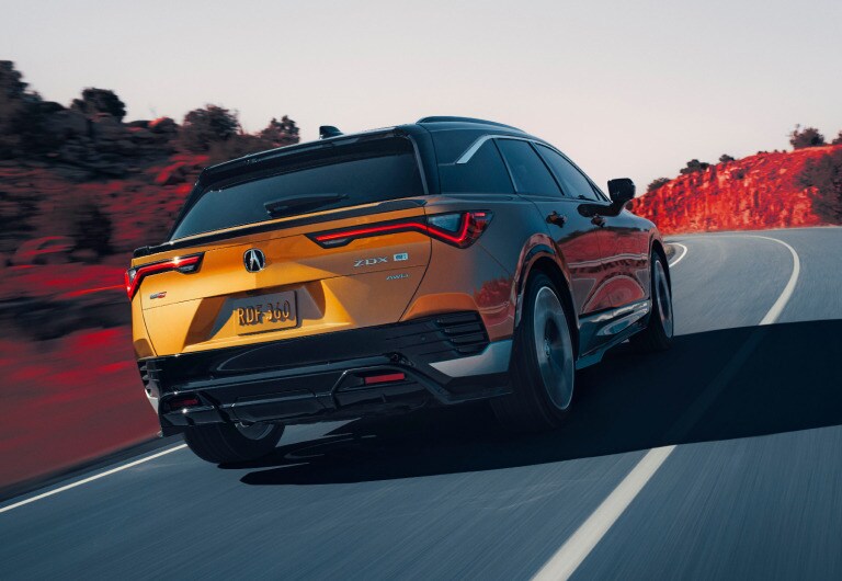 2024 Acura ZDX Type S in Tiger Eye Pearl on the road 2024 Acura ZDX Type S in Tiger Eye Pearl on the road