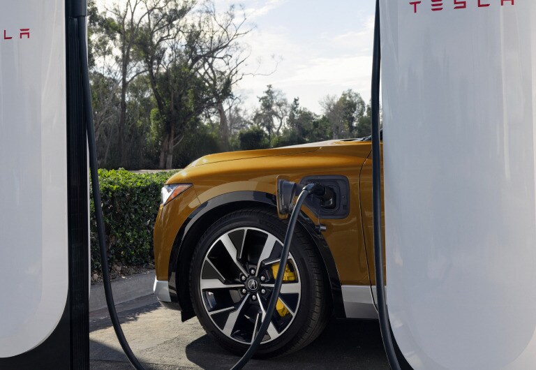 2025 Acura ZDX charging on the road 2025 Acura ZDX charging on the road