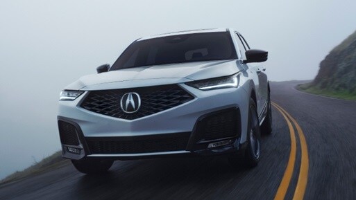 MDX front 3/4 action shot in Platinum White Pearl  MDX front 3/4 action shot in Platinum White Pearl