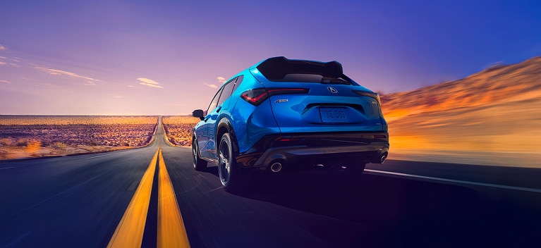 2026 Acura ADX A-Spec shown in Double Apex Blue Pearl II, driving on the road. 2026 Acura ADX A-Spec shown in Double Apex Blue Pearl II, driving on the road.