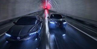 Two 2025 Integra driving in a tunnel, top front view Two 2025 Integra driving in a tunnel, top front view