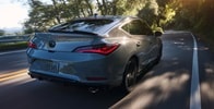 2026 Acura Integra car in Urban Gray Pearl driving on the road. 2026 Acura Integra car in Urban Gray Pearl driving on the road.