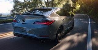 2026 Acura Integra car in Urban Gray Pearl driving on the road. 2026 Acura Integra car in Urban Gray Pearl driving on the road.