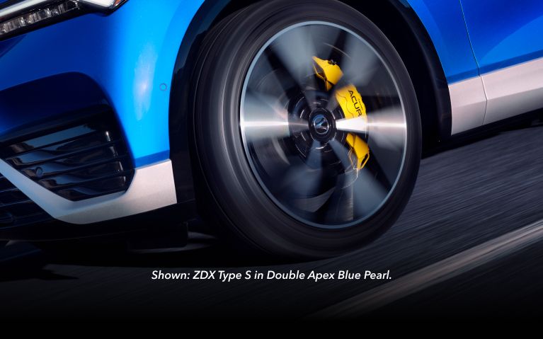 2024 Acura ZDX Type S in Double Apex Blue Pearl, detail of the front wheel in motion 2024 Acura ZDX Type S in Double Apex Blue Pearl, detail of the front wheel in motion