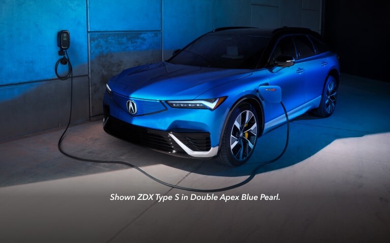 2024 Acura ZDX Type S in Double Apex Blue Pearl next to charging station 2024 Acura ZDX Type S in Double Apex Blue Pearl next to charging station