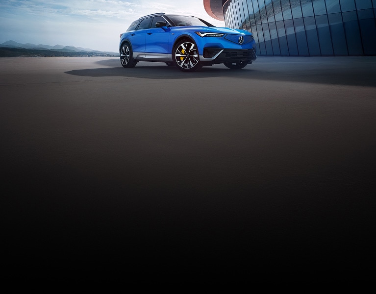 2024 Acura ZDX Type S in Double Apex Blue Pearl, parked in front of a modern building (Premium All-Electric SUV). 2024 Acura ZDX Type S in Double Apex Blue Pearl, parked in front of a modern building (Premium All-Electric SUV).