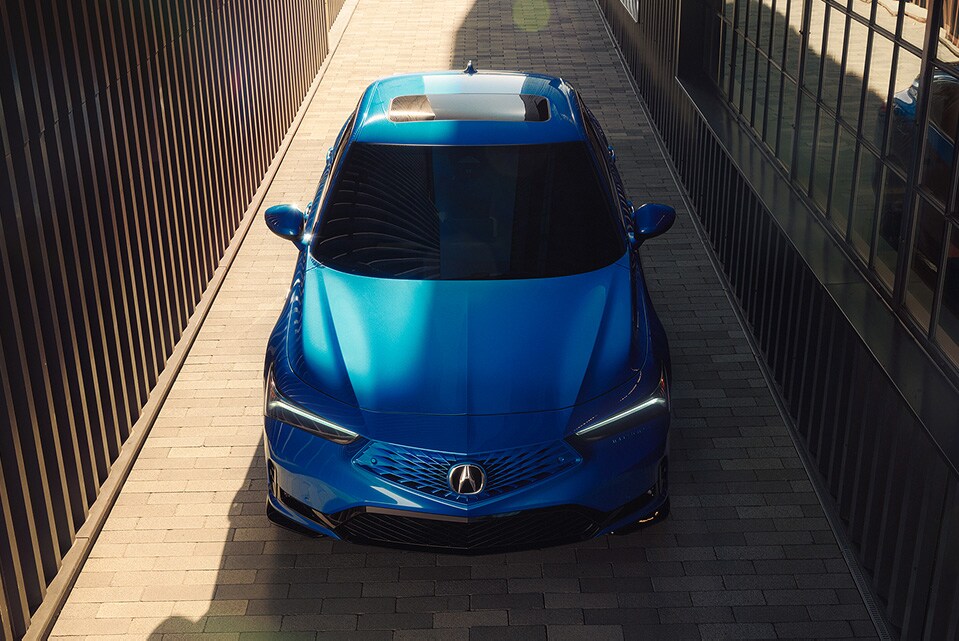 2026 Acura Integra A-Spec with Technology Package in Double Apex Blue Pearl, top front view (Premium Sport Compact). 2026 Acura Integra A-Spec with Technology Package in Double Apex Blue Pearl, top front view (Premium Sport Compact).